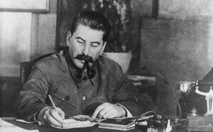 Joseph stalin writing at a desk.jpg